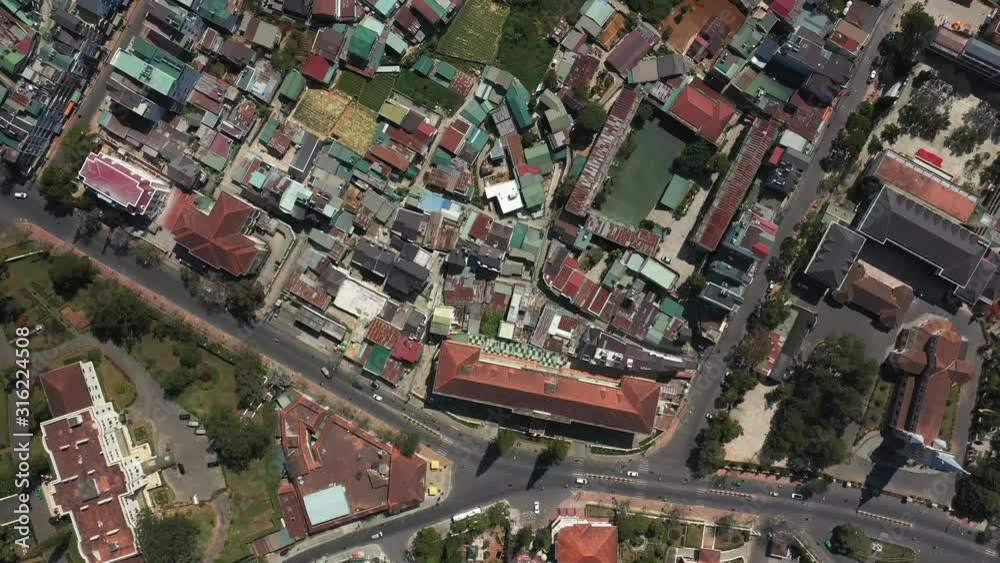 Top down drone shot of buildings, landscaping near the city center of Da Lat or Dalat in the Central Highlands of Vietnam on sunny day. Top down drone shot of buildings, landscaping near the city center of Da Lat or Dalat in the Central Highlands of Vietnam on sunny day.