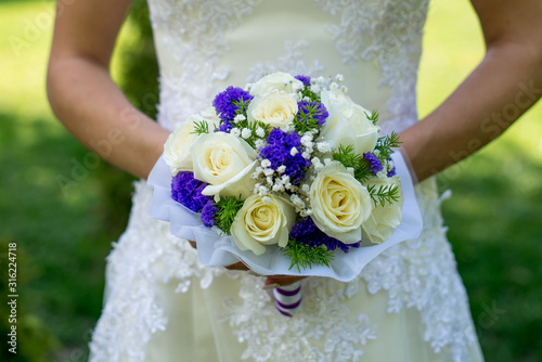 Beautiful wedding bouquet in hands of the bride.