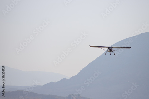 airplane in the sky, over mountains