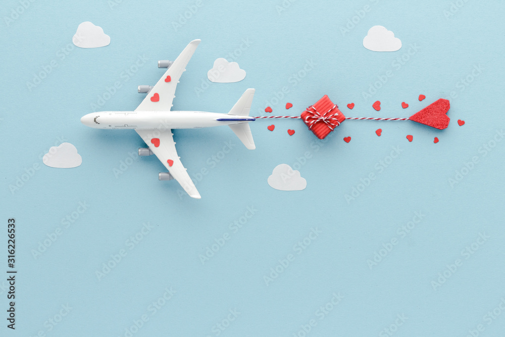 Fototapeta White top view Airplane .Airplane hearts gift blue cloud sky background with copy space for your text. Flat lay.