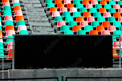 Black wall for text with space. Free brand wall. Background with Empty seat chairs at stadium photo