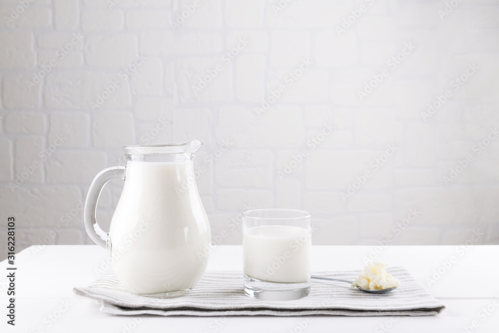 Homemade fermented beverage kefir with kefir grains in bowl on a white background, concept of natural fermented food and intestinal health Homemade fermented beverage kefir with kefir grains in bowl on a white background, concept of natural fermented food and intestinal health