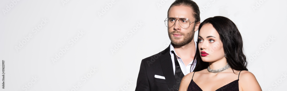 panoramic shot of young couple in black suit and dress isolated on white panoramic shot of young couple in black suit and dress isolated on white