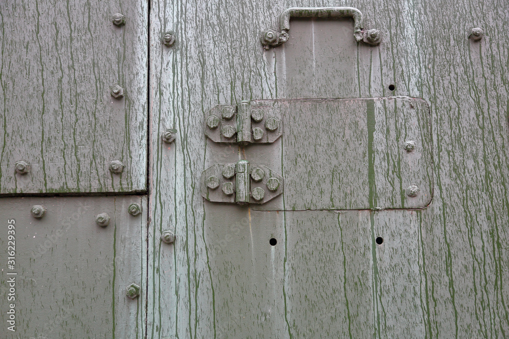 Green textured surface of armored metal with roughness and scratches