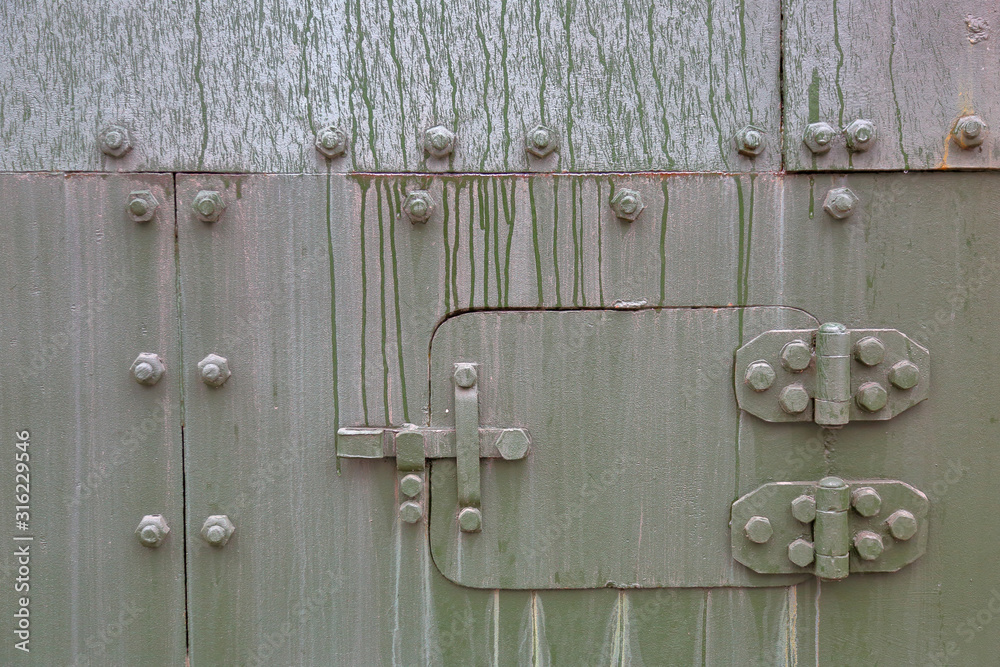 Green textured surface of armored metal with roughness and scratches