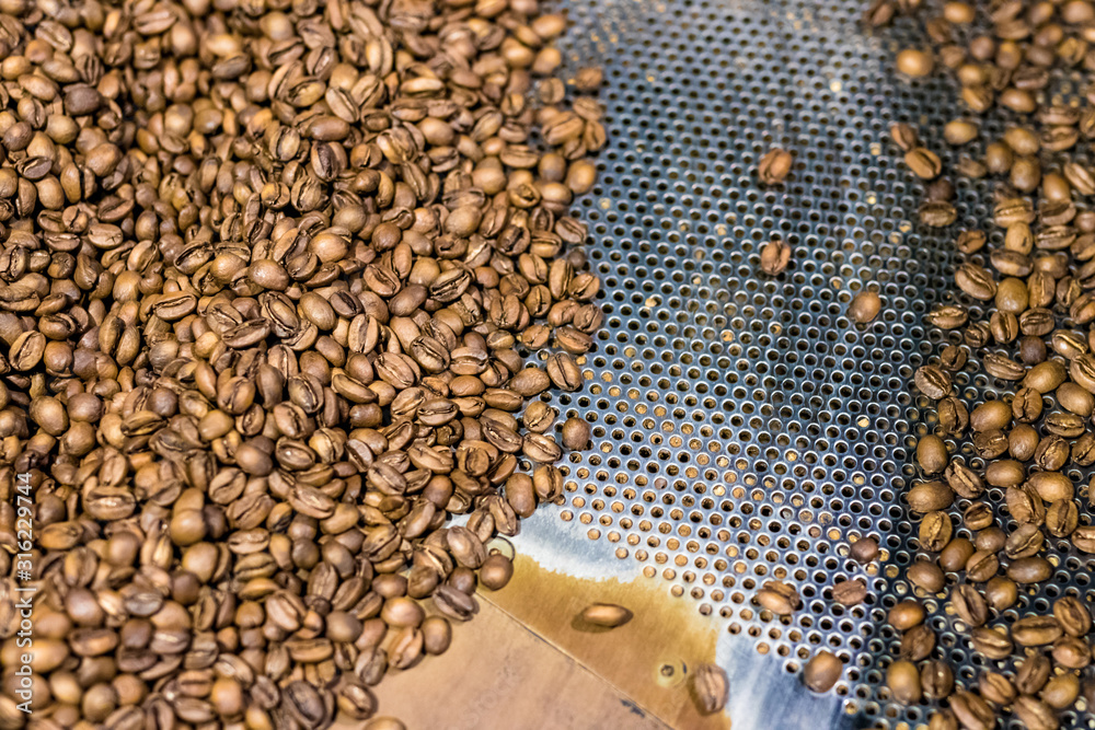 Fresh roasted coffee arabica beans have been cooled down in the roaster