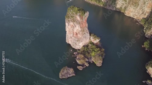 Huge rock above the water in Railay beach in Krabi in Thailand next to a luxury Resort