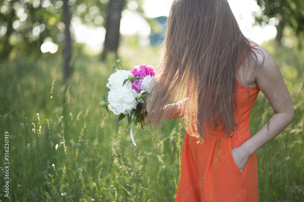 woman smelling flowers pink and white peonyin garden woman smelling flowers pink and white peonyin garden