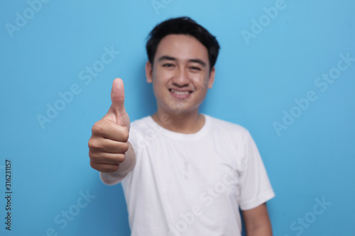 Young Man Showing Thumbs Up Gesture OK Sign © airdone