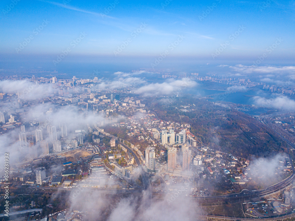 Aerial drone cityscape. Kiev city houses under rare clouds, top view.