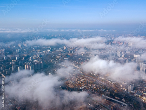 Aerial drone cityscape. Kiev city houses under rare clouds  top view.