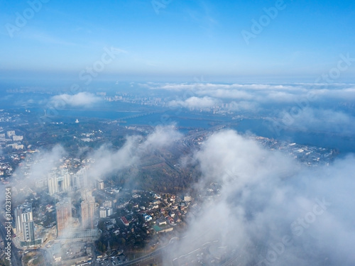 Aerial drone cityscape. Kiev city houses under rare clouds  top view.