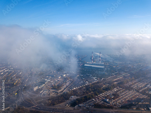 Aerial drone cityscape. Kiev city houses under rare clouds, top view.