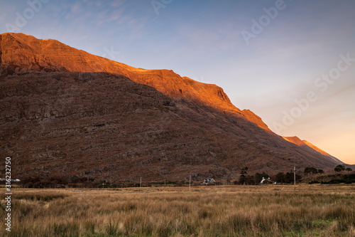 A full frame braketed hdr image of the winter sun setting on the Torridon mountains Liathach and Beinn Eighe  Wester Ross  Scotland. 31 December 2019