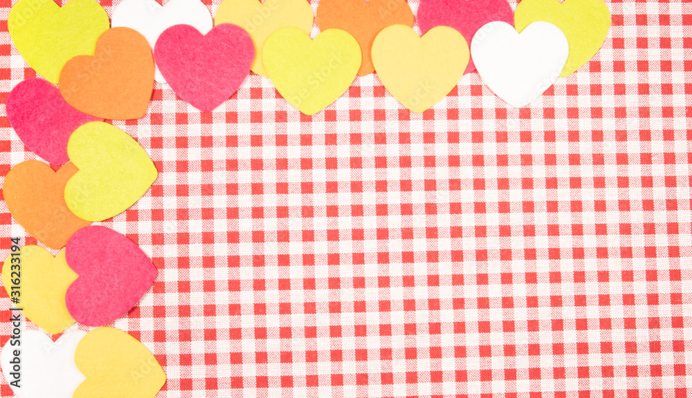 background with red and white Vichy fabric for Valentine's Day with pink, orange, yellow and white hearts. valentines day concept background with red and white Vichy fabric for Valentine's Day with pink, orange, yellow and white hearts. valentines day concept