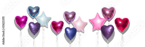 Air Balloons. Bunch of purple heart shaped foil balloons, isolated on white background. Love. Holiday celebration. Valentine's purple, red, pink, blue. Day party decoration. Metallic balloon Birthday