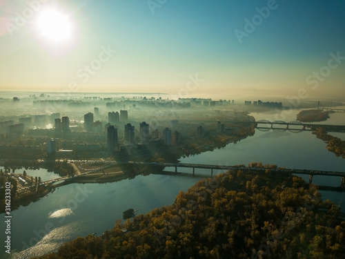 Aerial drone view. A view of the Dnieper River and the city of Kiev, shrouded in a light morning fog.