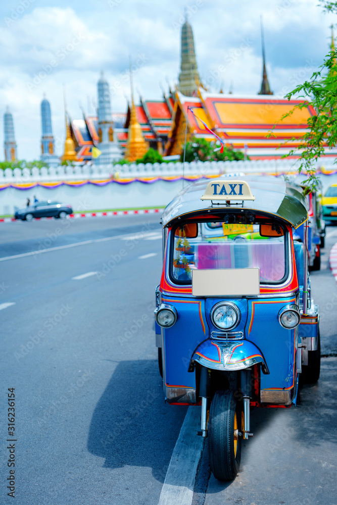 asia local travel in city activity with local taxi (tuk tuk) parking for  wait tourism on street of bangkok Thailand with grandpalace landmark  background Stock Photo | Adobe Stock