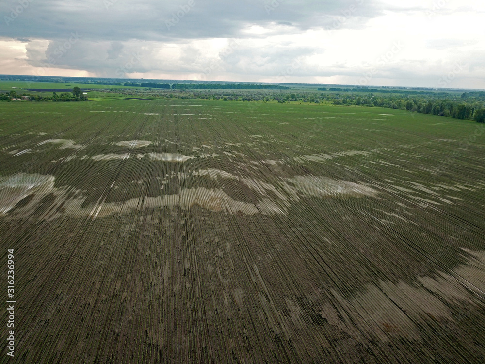 Aerial drone view. Plowed field in early spring. Aerial drone view. Plowed field in early spring.