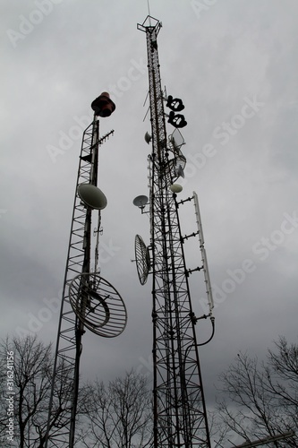 Telecom towers with gray skies