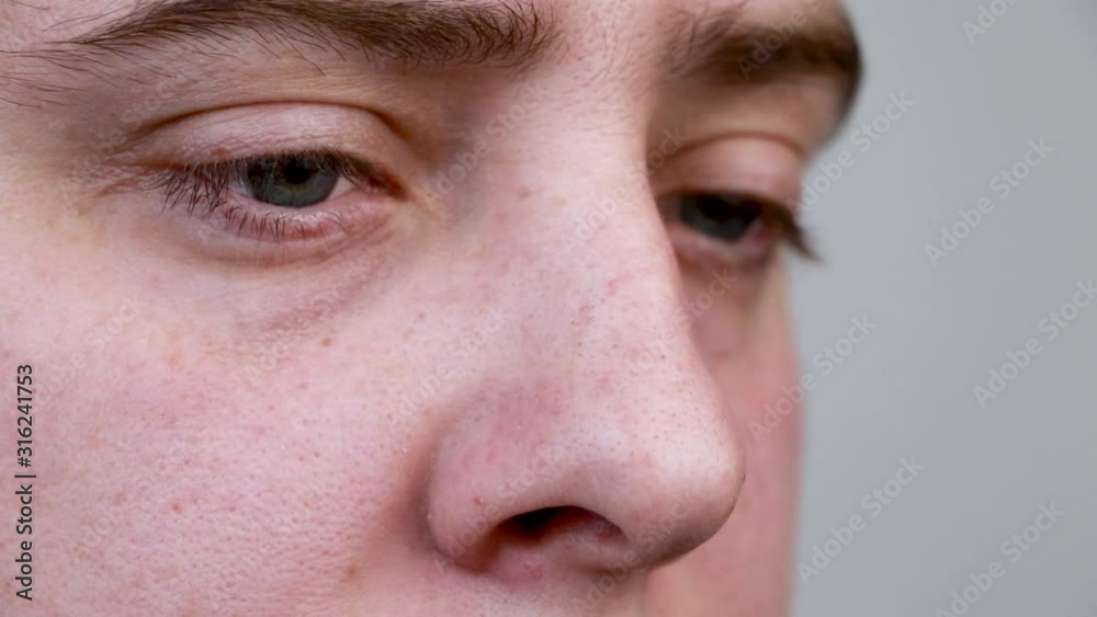 Close-up of the eyes of a man reading a book. Pupils move side to side as a man reads. Macro video Close-up of the eyes of a man reading a book. Pupils move side to side as a man reads. Macro video