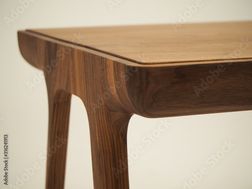 legs and edge of the table top of a beautiful table made of natural wood photo