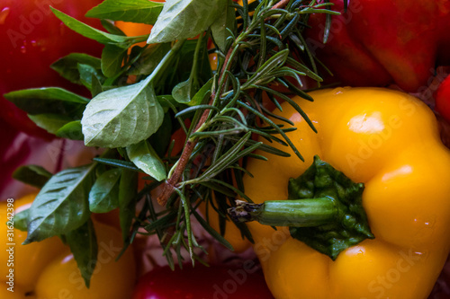 Hand putting salt on roasted colorful and natural vegetables cooking at home on background with space for text, selective focus