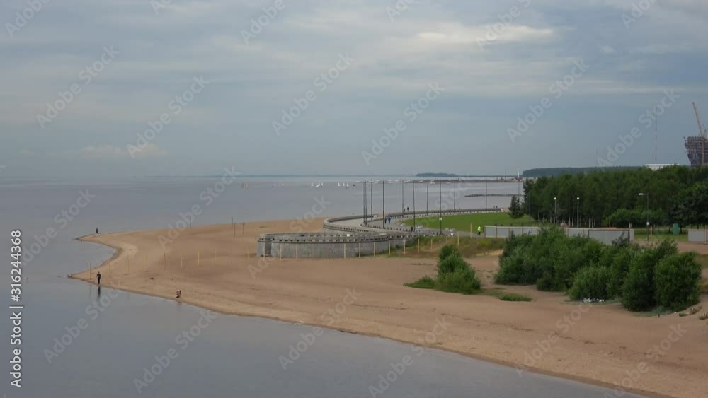 Landscape with Finland Gulf, sand public beach in the St - Petersburg, Russia. View from the Yahtennyi Bridge. Landscape with Finland Gulf, sand public beach in the St - Petersburg, Russia. View from the Yahtennyi Bridge.