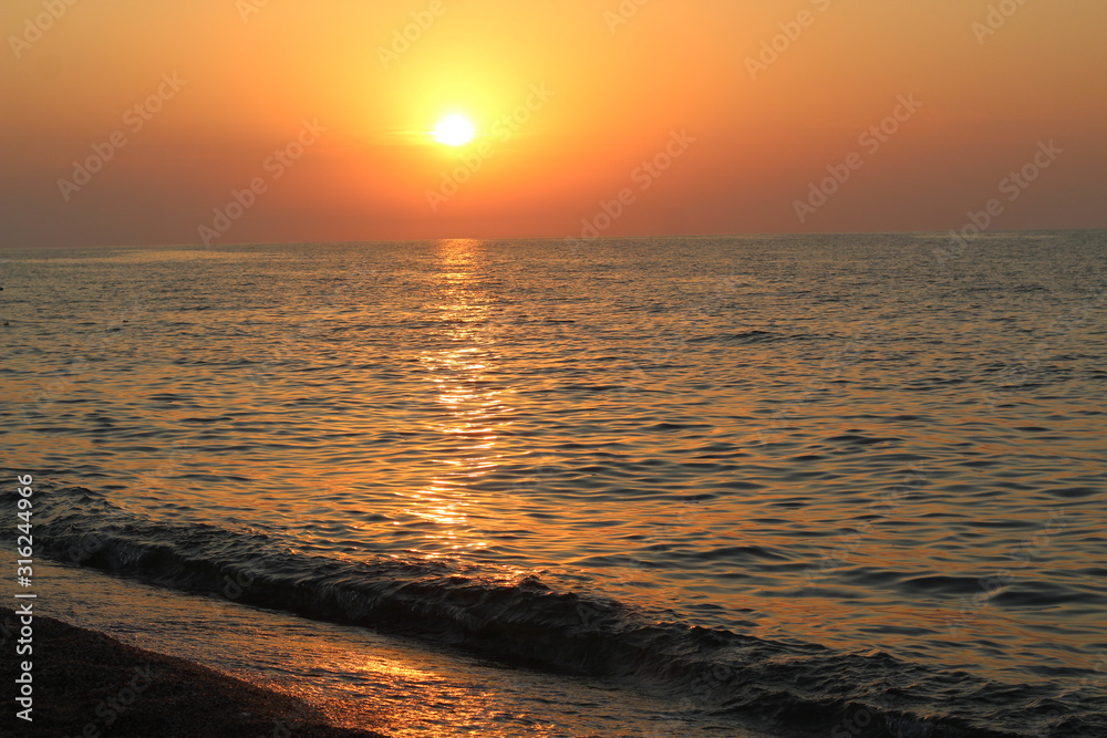 Beautiful sunset above the sea in summer