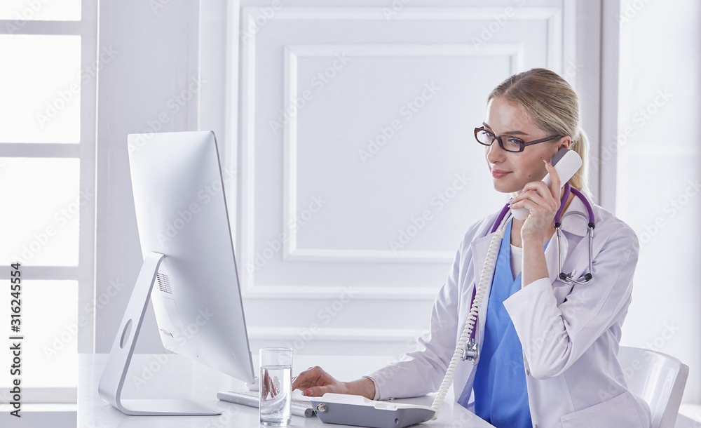 Portrait of a happy smiling young doctor in headset in office Portrait of a happy smiling young doctor in headset in office