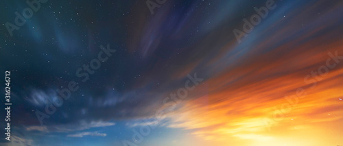 Long exposure clouds at the starry sky. Bright moon light behind the colorful clouds. Night photography. Astronomical background.