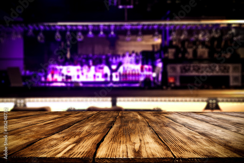 Table background of free space and blurred bar background  © magdal3na
