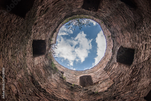 View of blue sky with white clouds through tower of Akkerman. Bilhorod-Dnistrovskyi, Odesa oblast, Ukraine photo