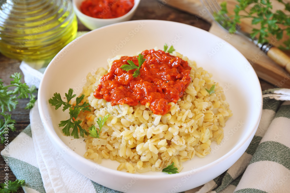 Pearl barley with tomato sauce and grated parmesan cheese Pearl barley with tomato sauce and grated parmesan cheese