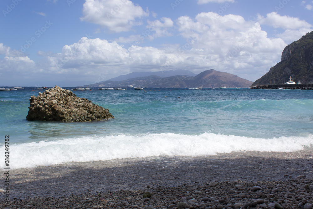 blue sea water summer beach with island rocks sky clouds panoramic view blue sea water summer beach with island rocks sky clouds panoramic view
