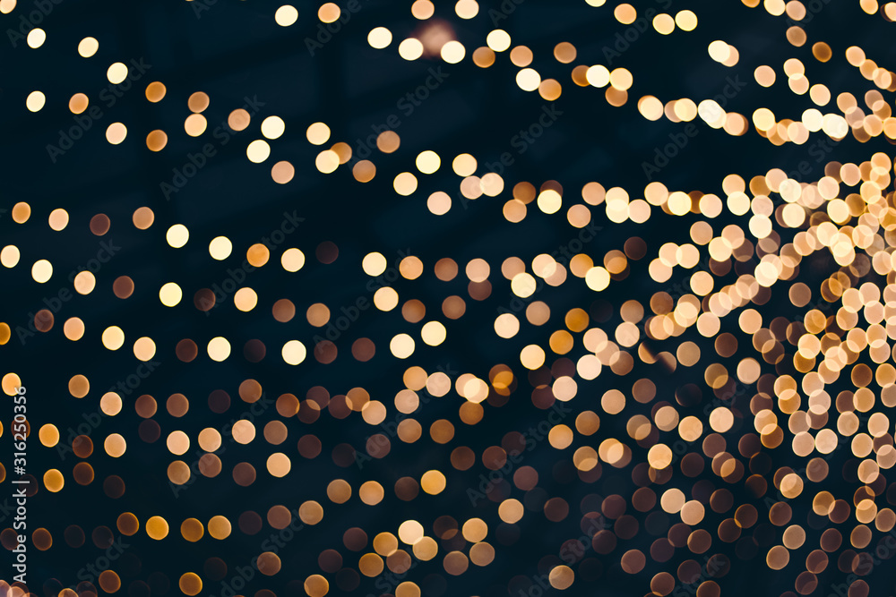 Decorative outdoor string lights at night time, Defocused Background, night city life backdrop, party time with Yellow bokeh balls - obrazy, fototapety, plakaty 