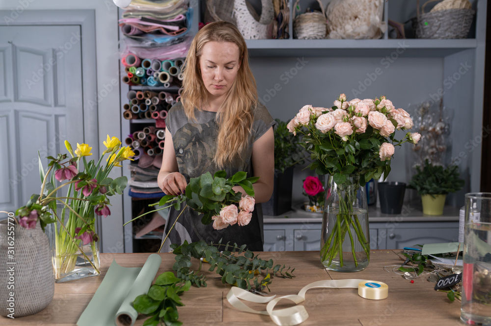 Floral shop concept . Florist woman creates flower bouquet. Beautiful bouquet of mixed flowers. Handsome fresh bunch. Flowers delivery Floral shop concept . Florist woman creates flower bouquet. Beautiful bouquet of mixed flowers. Handsome fresh bunch. Flowers delivery