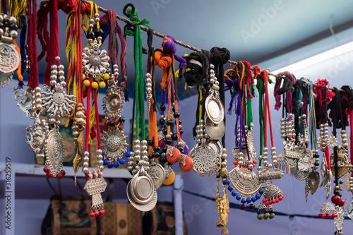 Picture of antique handmade Indian gemstone necklace is displayed in a street shop for sale. Indian handicraft and art