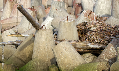 breakwater around sea port is made of concrete tetrapods photo