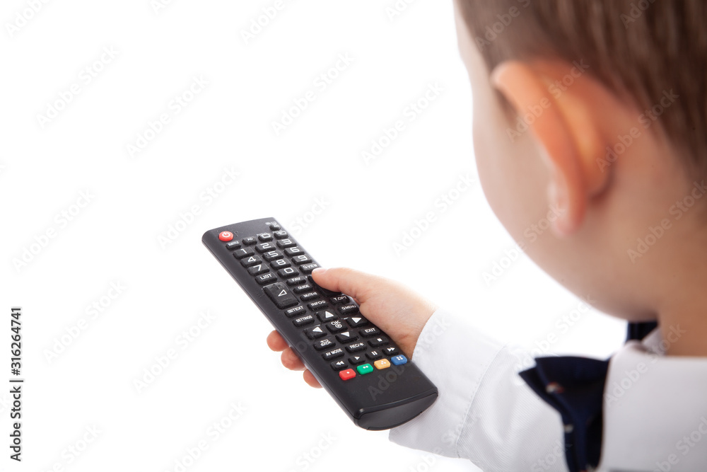 Little boy changing channels on TV using remote control, isolated on white. Empty space Little boy changing channels on TV using remote control, isolated on white. Empty space