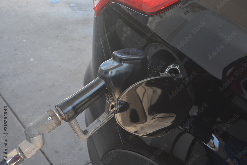 pumping gas into a suv pumping gas into a suv
