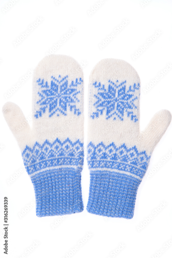 Warm woolen knitted mittens isolated on white background. Blue knitted mittens with pattern Warm woolen knitted mittens isolated on white background. Blue knitted mittens with pattern