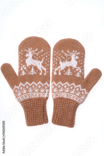 Warm woolen knitted mittens isolated on white background. Brown knitted mittens with pattern
