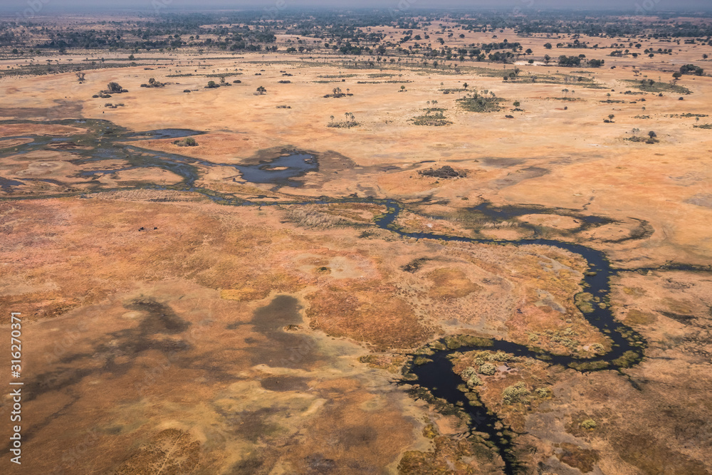 Φωτογραφία Okavango Delta Aerial, Stunning, Colorful Dry Landscape With Dark Blue River and