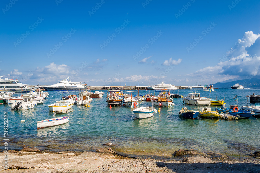 Fishing boats at Capri marina. Capri island, popular Italian travel destination.