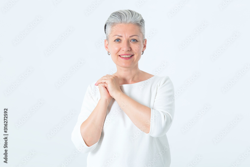 Portrait of a mature woman with a short haircut and gray hair. Beautiful female on light background. Portrait of a mature woman with a short haircut and gray hair. Beautiful female on light background.