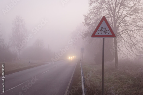 warning bicycle sign at a foggy road