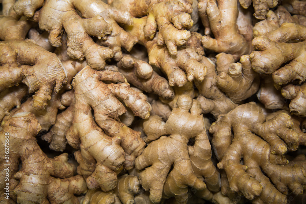 Fresh yellow ginger roots in a plastic box. Vegetables, fruits, useful products. Fresh yellow ginger roots in a plastic box. Vegetables, fruits, useful products.