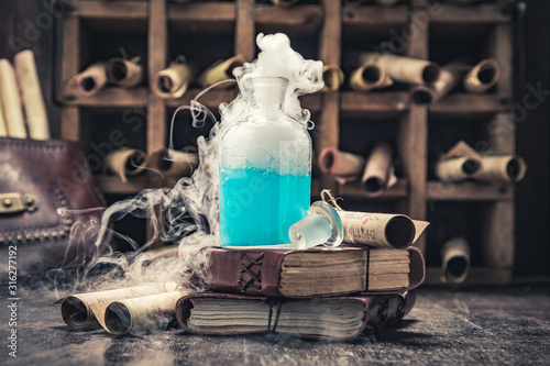 Vintage alchemist laboratory with unique scrolls and manuscripts photo