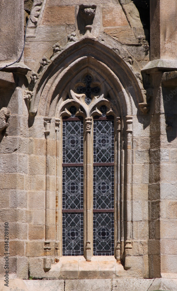 Pointed window with gothic tracery at Saint Sauveur basilica in Dinan city, Brittany in France